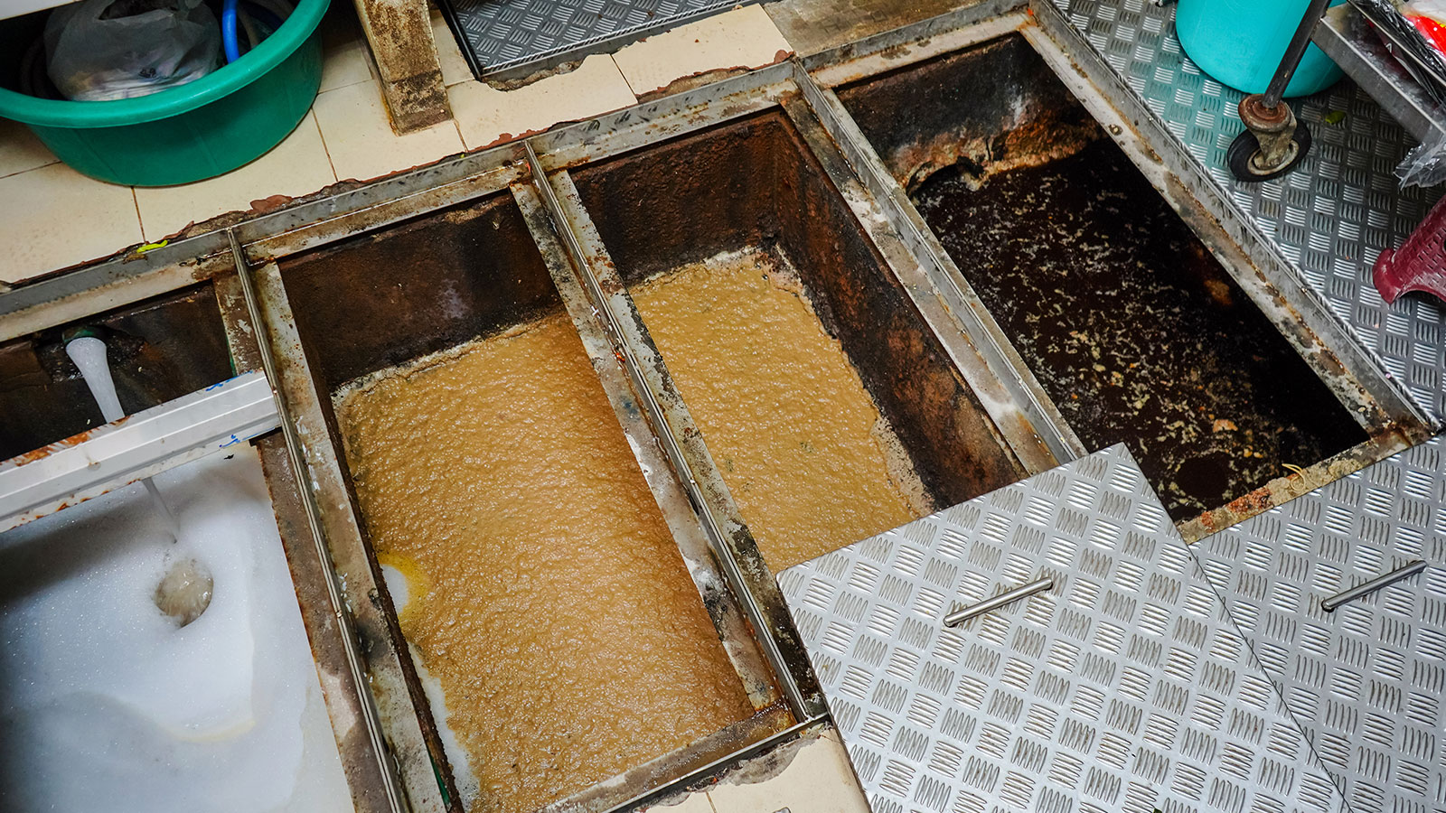 Commercial grease trap being pumped